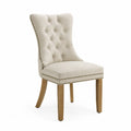 Chaise de salle à manger capitonnée dossier haut tissu beige pieds en bois naturel style clouté